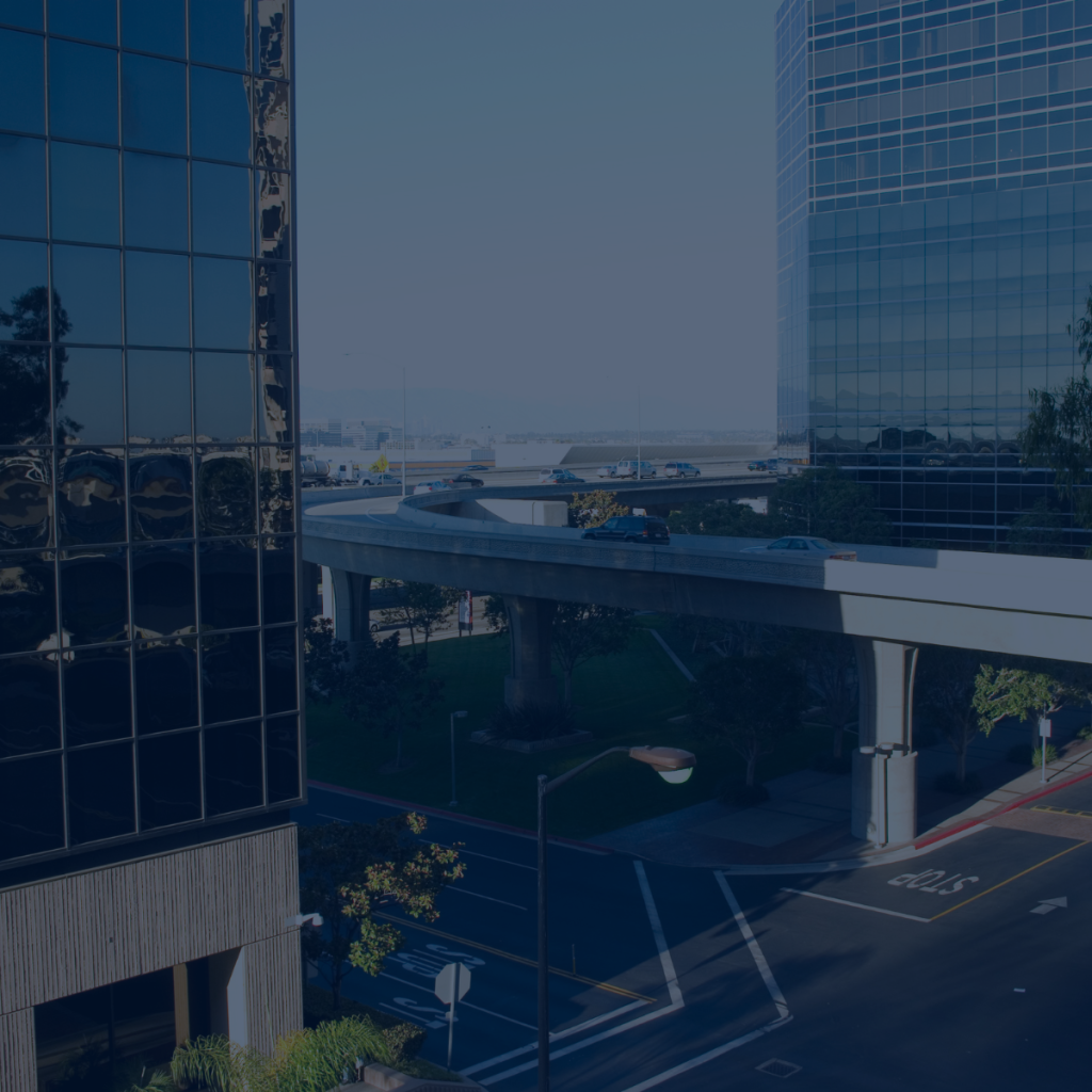 Business district at dawn with empty offices and an elevated road, illustrating business continuity planning for SMEs
