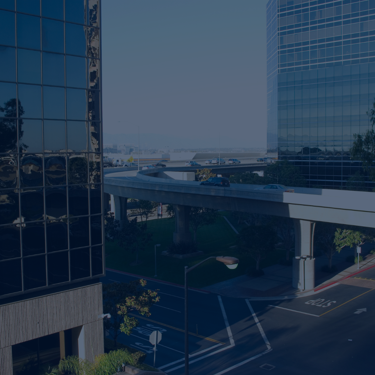 Business district at dawn with empty offices and an elevated road, illustrating business continuity planning for SMEs